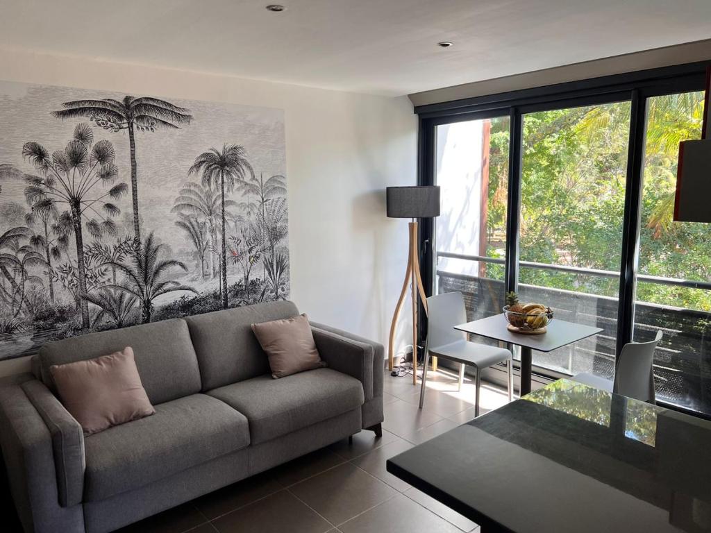 a living room with a couch and a table at Ô LAGON in Saint-Gilles les Bains