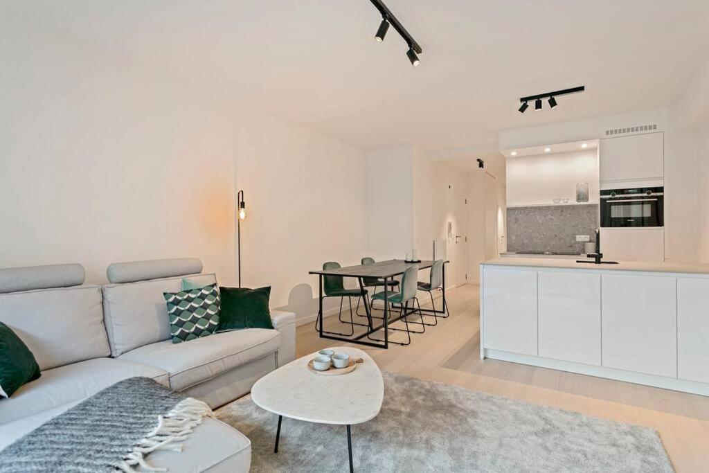 a living room with a couch and a table at Sun & sea Knokke in Knokke-Heist