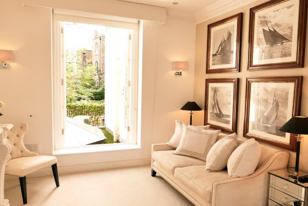 a living room with a couch and a window at Belgravia flat, with private Terrace in London