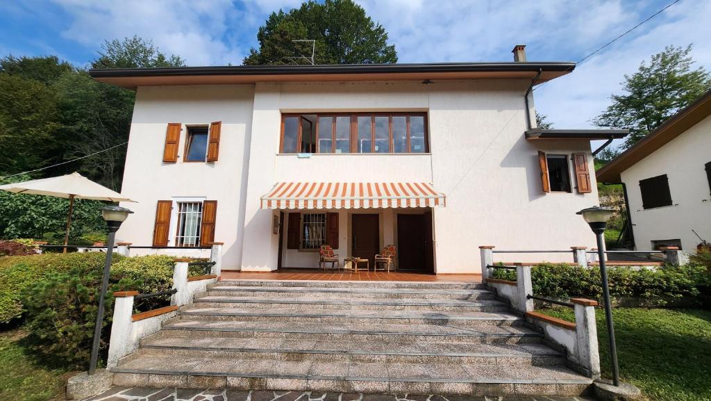 a house with a staircase leading up to it at Casolare Nanis in Travesio