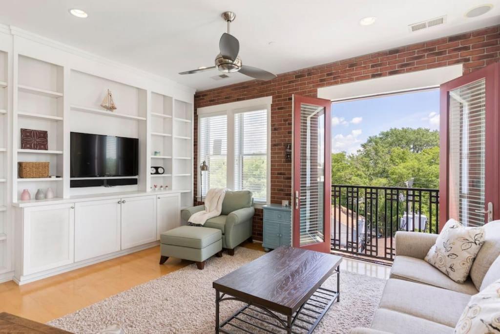 a living room with a couch and a tv at Brooklyn Arts Condo in Wilmington