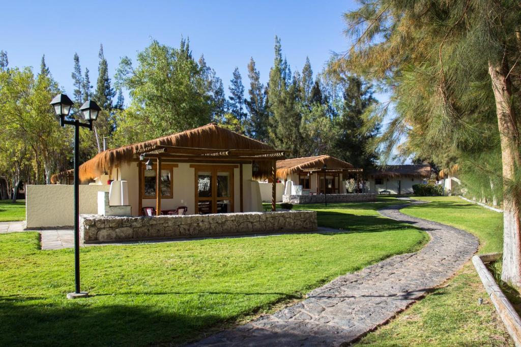 a house with a pathway leading into a yard at Cabañas La Huayca - Caja Los Andes in Pica