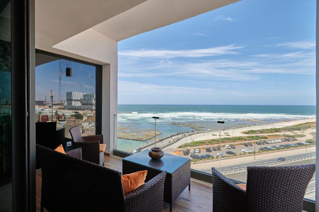 a room with a view of the beach and the ocean at Apartment Sea View B29 -Mosquée Hassan II- By TheCasaEdition in Casablanca