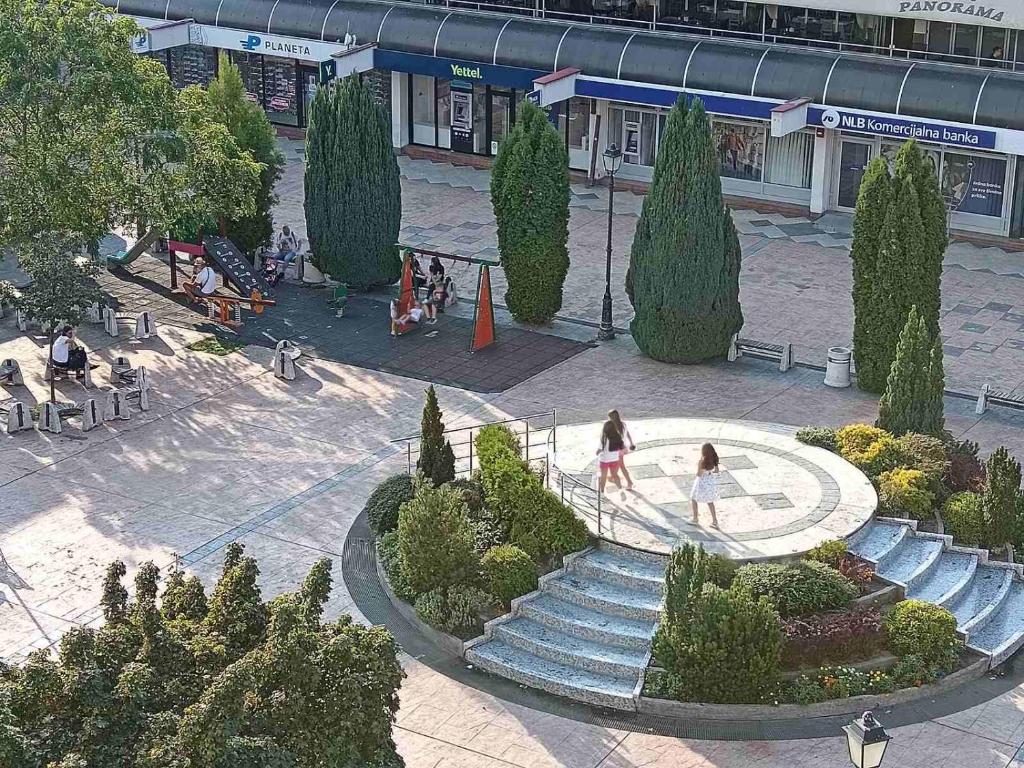 a group of people walking down stairs in a park at Red Square Apartment in Pirot