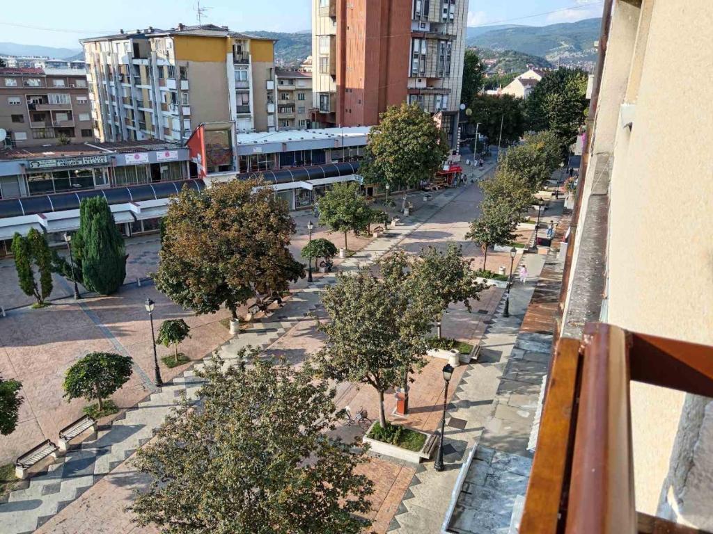 a view of a street with trees and buildings at Red Square Apartment in Pirot