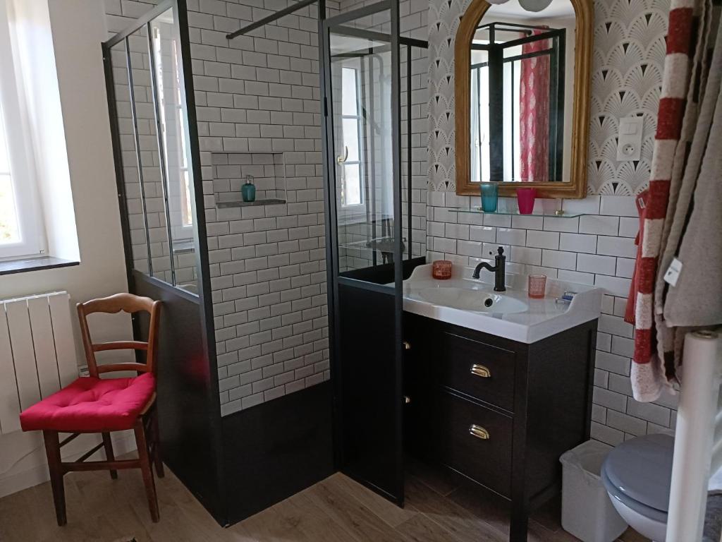 a bathroom with a shower and a sink and a mirror at Avenue du Château in Saint-Just