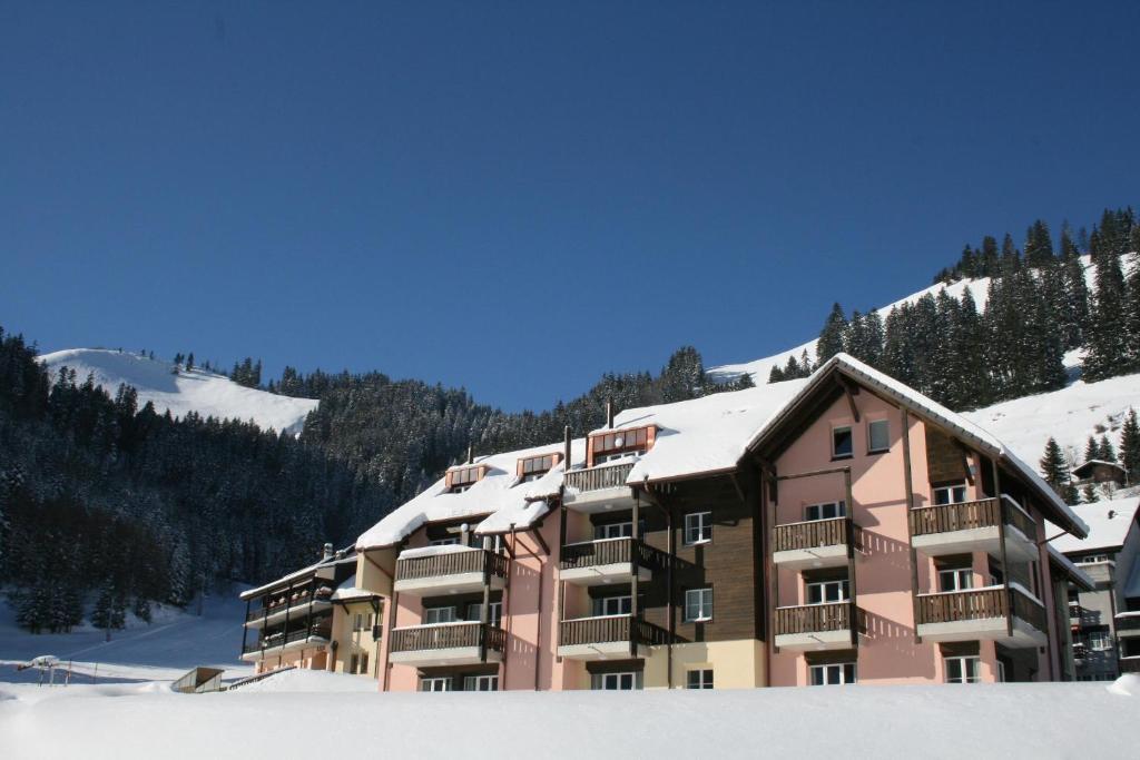 a large building with snow on top of it at Andromède, appartements 2 à 5p de standing in Moleson
