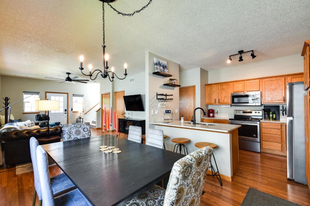 a kitchen and living room with a dining room table at Cozy Iowa City Home about 2 Mi to Kinnick Stadium! in Iowa City