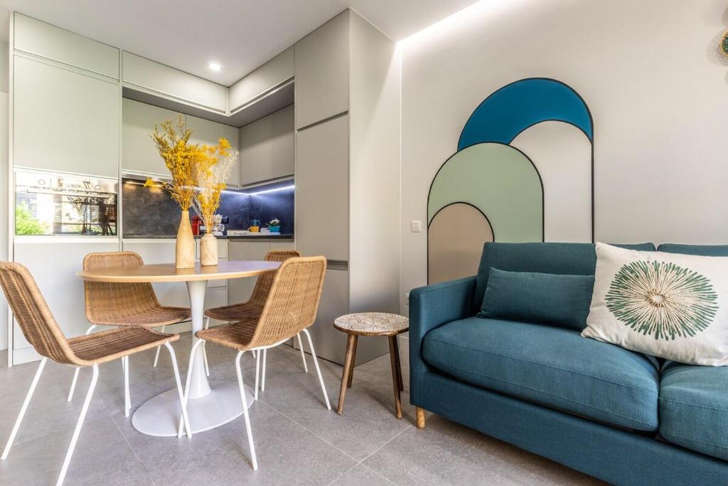 a living room with a blue couch and a table at Strahouse Stilish House in Maspalomas