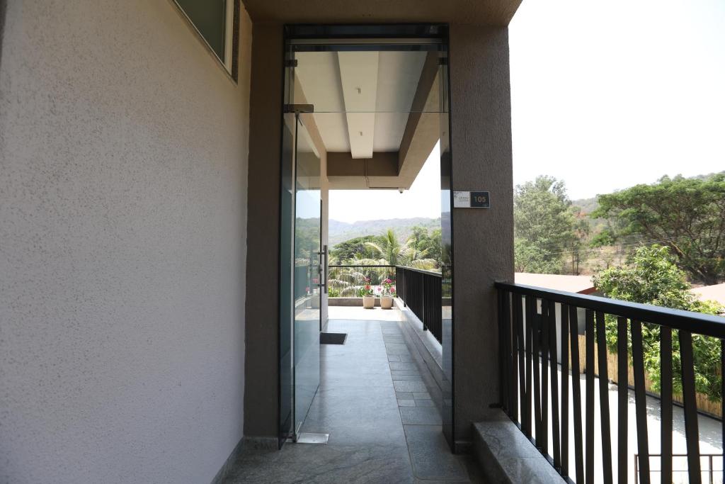 a hallway of a house with a balcony at Golden Fields Resort in Mulshi