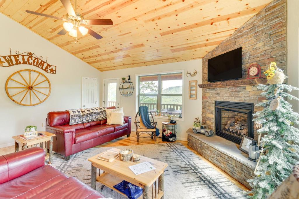 a living room with a couch and a fireplace at North Carolina Cabin - Pool Table and Mountain Views in Murphy