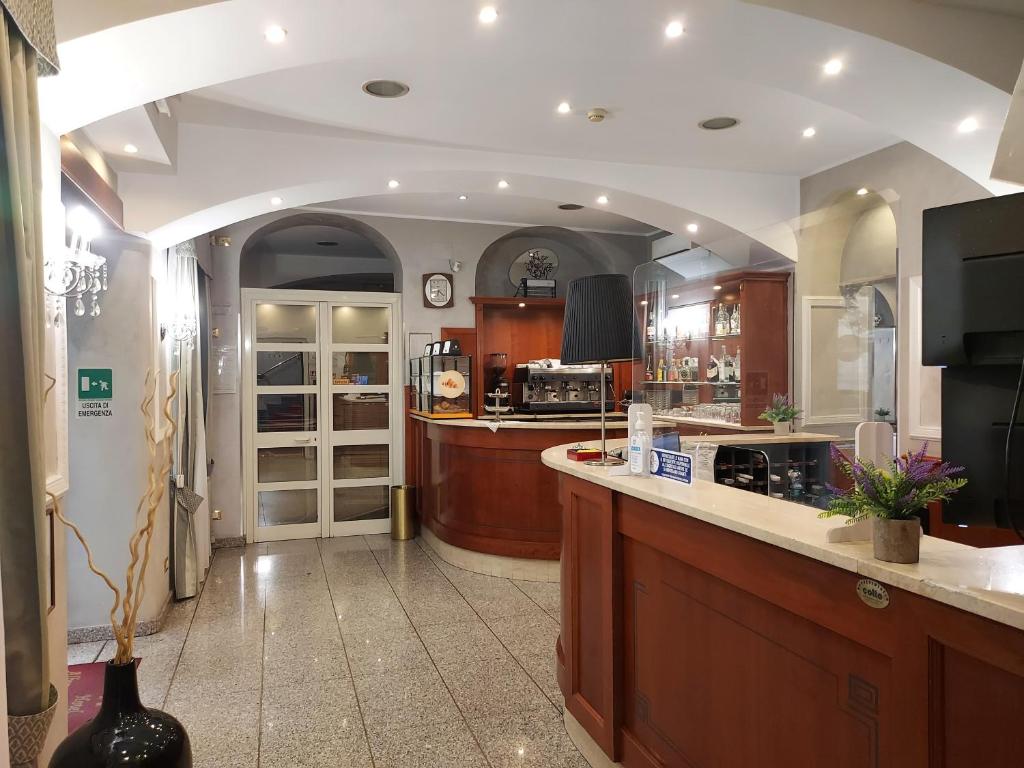 a large kitchen with a counter and a counter top at Hotel Antico Distretto in Turin