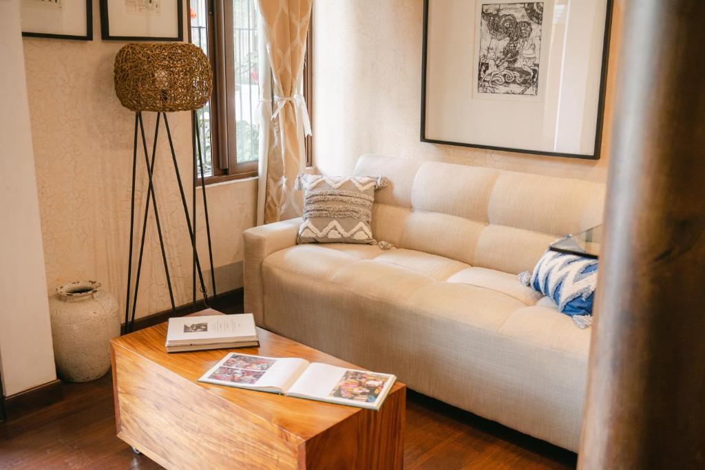 a living room with a white couch and a table at Boutique Villa in Antigua in Antigua Guatemala