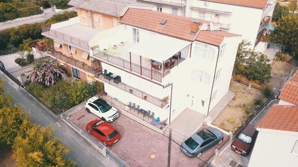 uma vista superior de uma casa com carros estacionados num parque de estacionamento em Apartment Marko em Kaštela