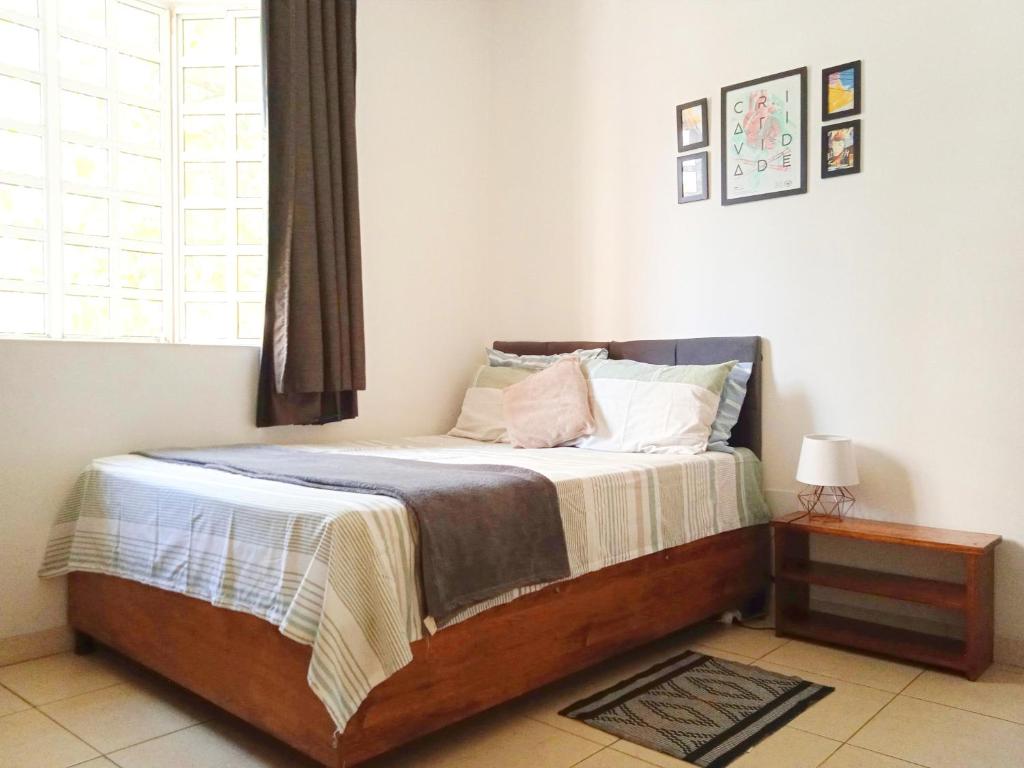a bedroom with a large bed with a window at Suíte com banheiro super espaçosa in Sao Paulo