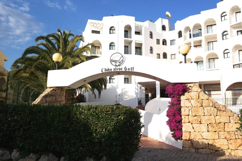 a white building with a sign that reads fila hotel at Apartamento Quinta Nova in Alvor