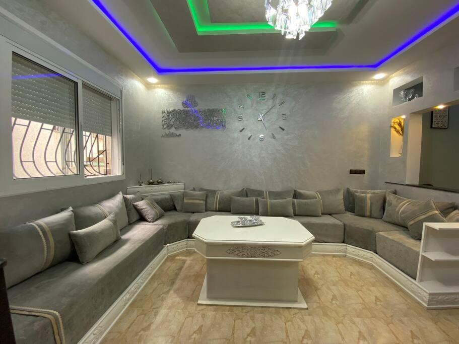 a living room with a couch and a table at Cozy apartment in Ksar el kebir in Ksar el Kebir