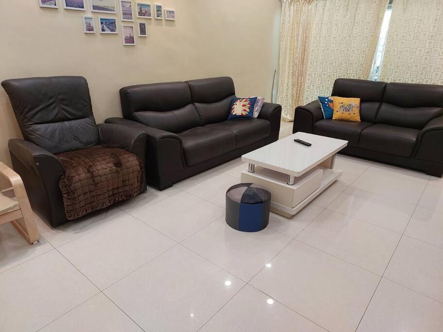 a living room with two couches and a coffee table at Home in Gelugor4R3B Dnaz Homestay@Sg. Dua in Gelugor