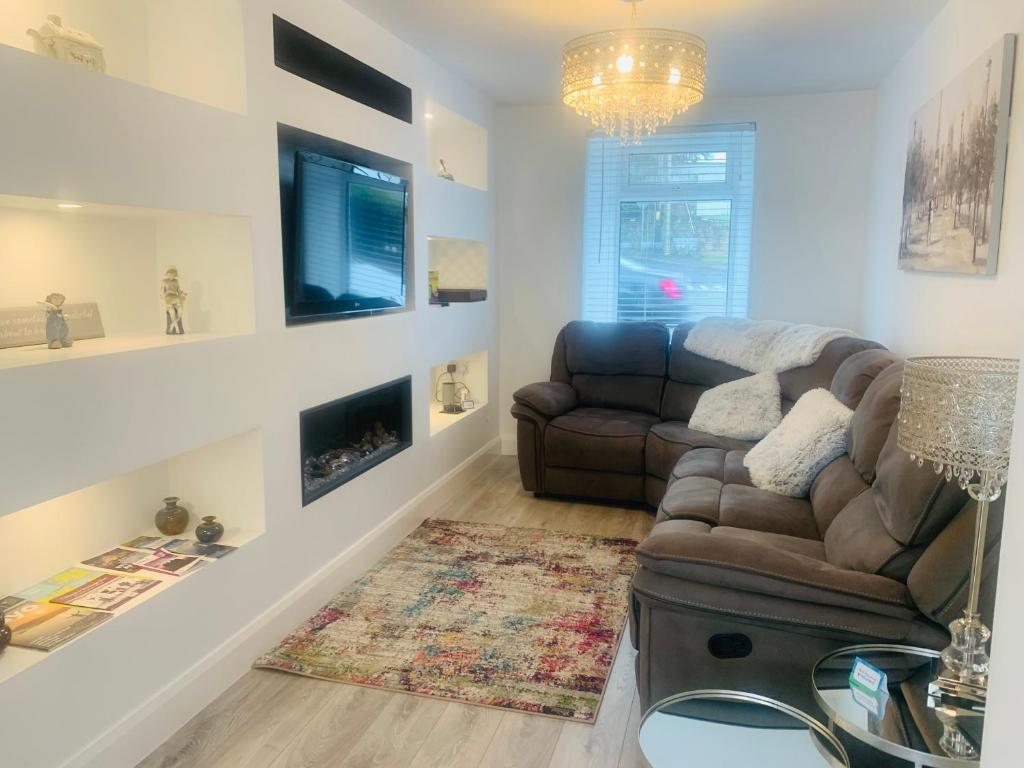 a living room with a couch and a fireplace at Station House in Ballina