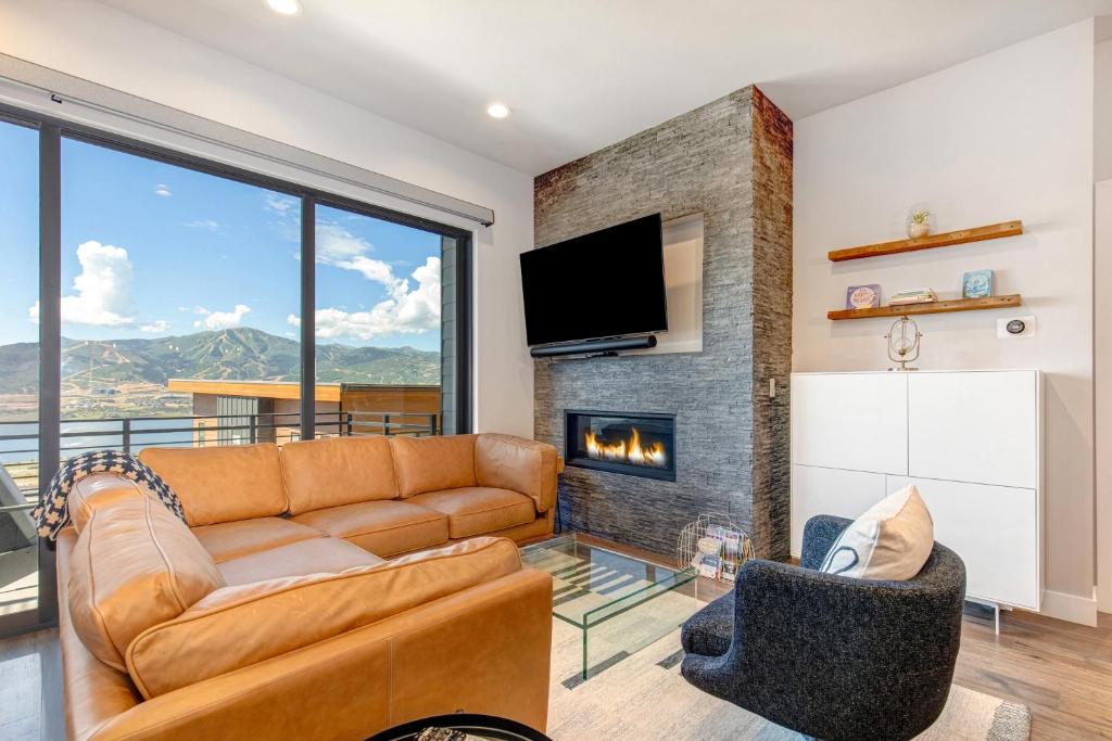 a living room with a couch and a fireplace at On Top of the Mountains - Full Townhome in Keetley