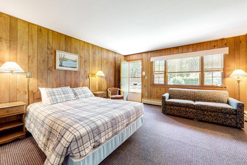 a bedroom with a bed and a couch and a chair at King Birch Lake Home, Unit 6 in Alton