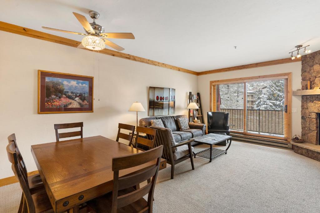 a living room with a dining room table and a couch at Snow Flower 206 in Steamboat Springs