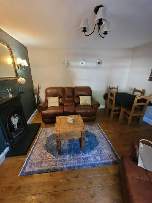 a living room with a couch and a coffee table at 2 Kilkerran Road in Campbeltown