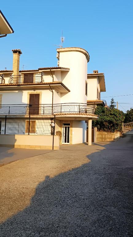 a large white building with a balcony on a street at B&B "LE LUCI" SUPER CAMERA IN ATTICO interno 3 in Vasto