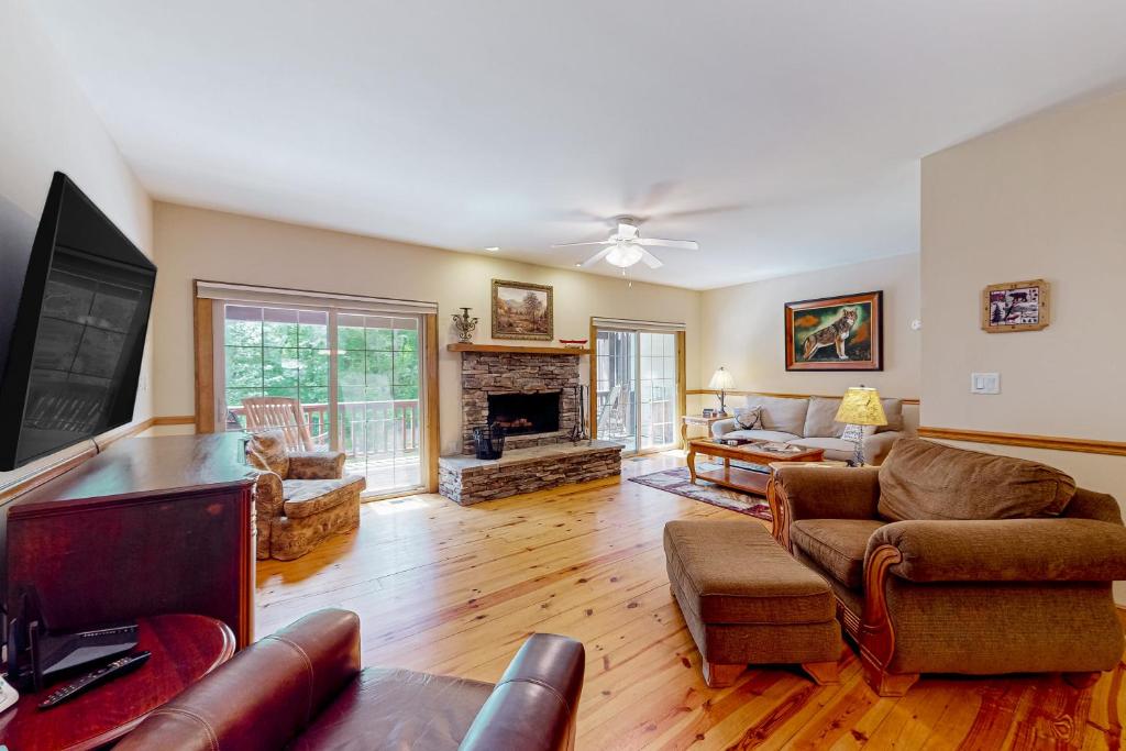 a living room filled with furniture and a fireplace at Sweet Home Carolina in Cashiers