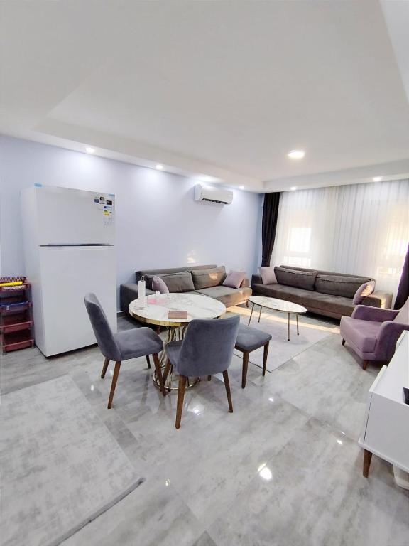 a living room with a table and chairs and a couch at Manolyam suit 5 .1+1 in Kaş