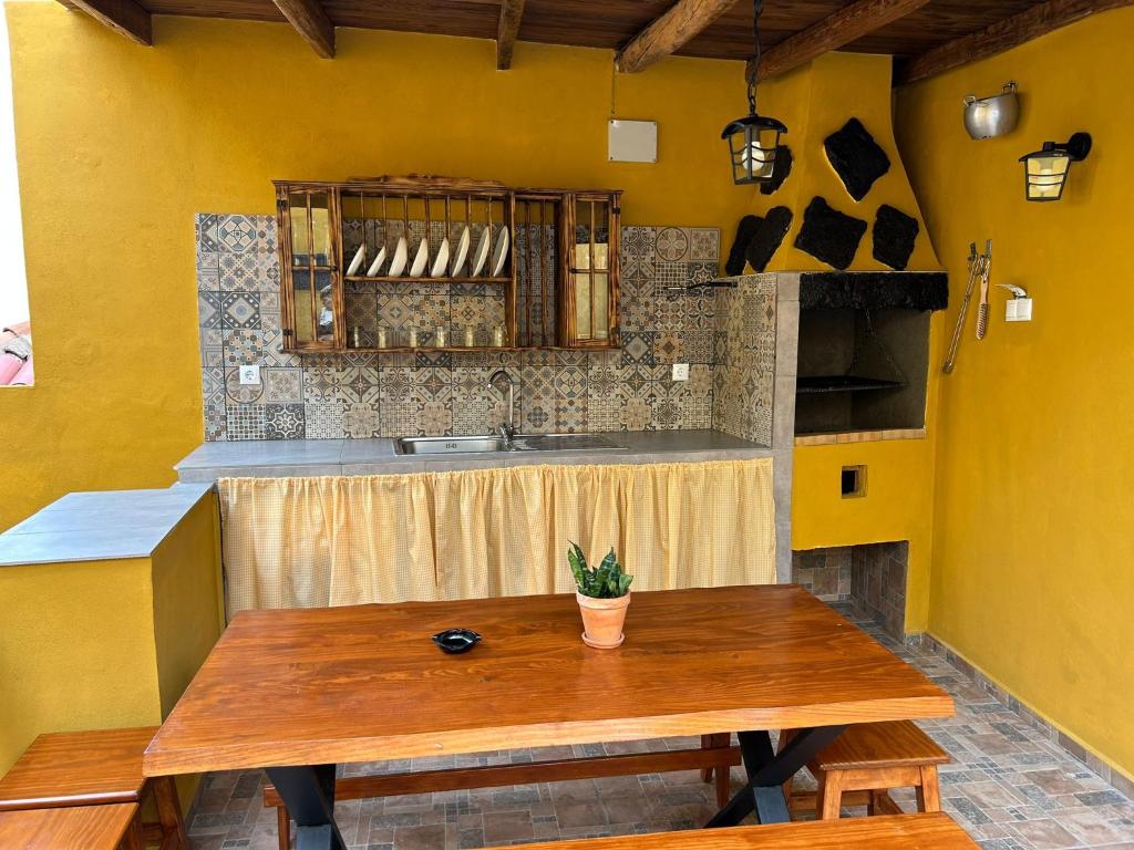a kitchen with a wooden table and a sink at Tradicional Casa Canaria con piscina y vistas al Teide in Icod de los Vinos