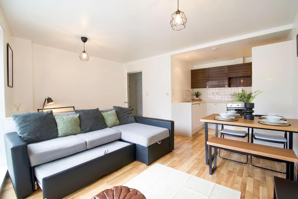a living room with a couch and a table at Perfect 1 bed flat in London