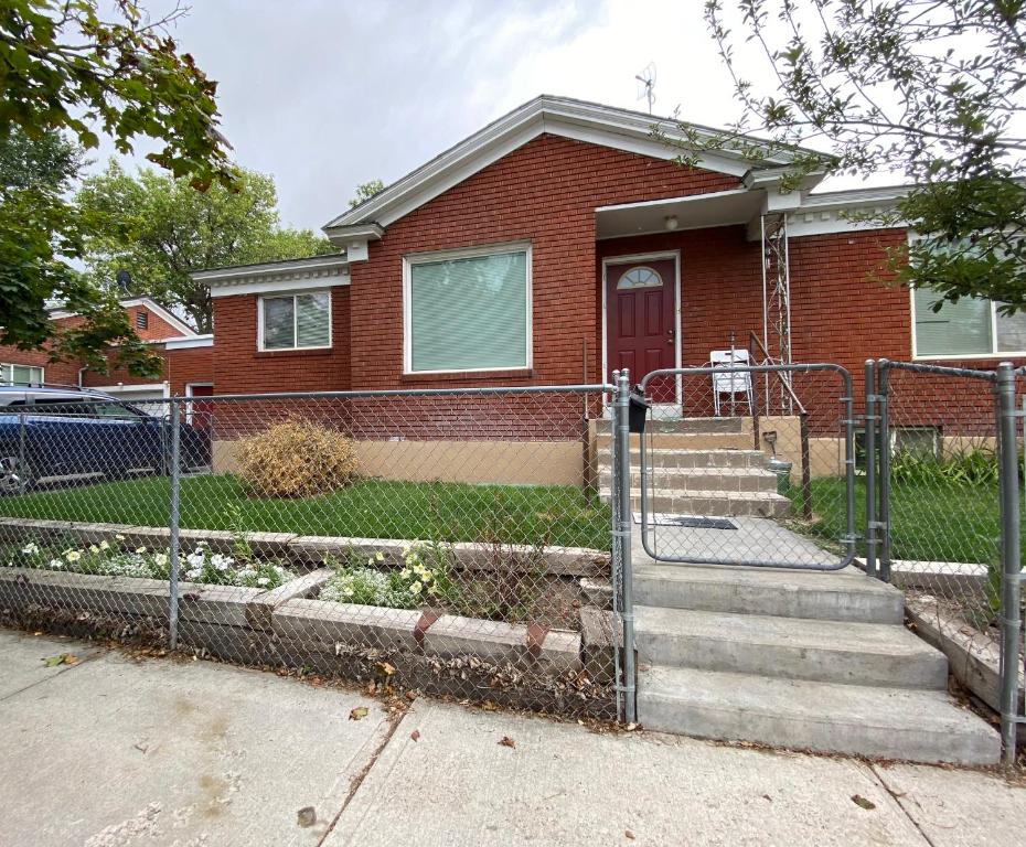 a red brick house with a red door at 1949 Sweet Sage House, CLOSE to Airport, Temple and Highway in Idaho Falls