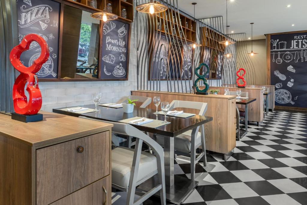 a restaurant with a table with a red snake sculpture at Crowne Plaza Airport by IHG in Tocumen