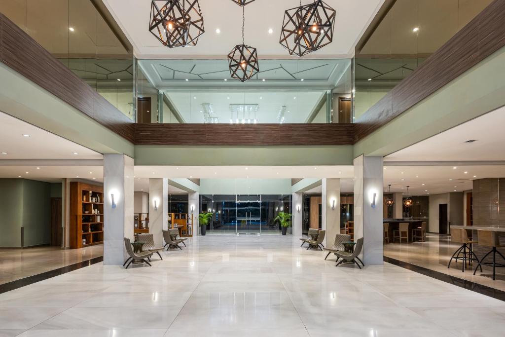 a lobby of a building with chairs and tables at Crowne Plaza Airport by IHG in Tocumen