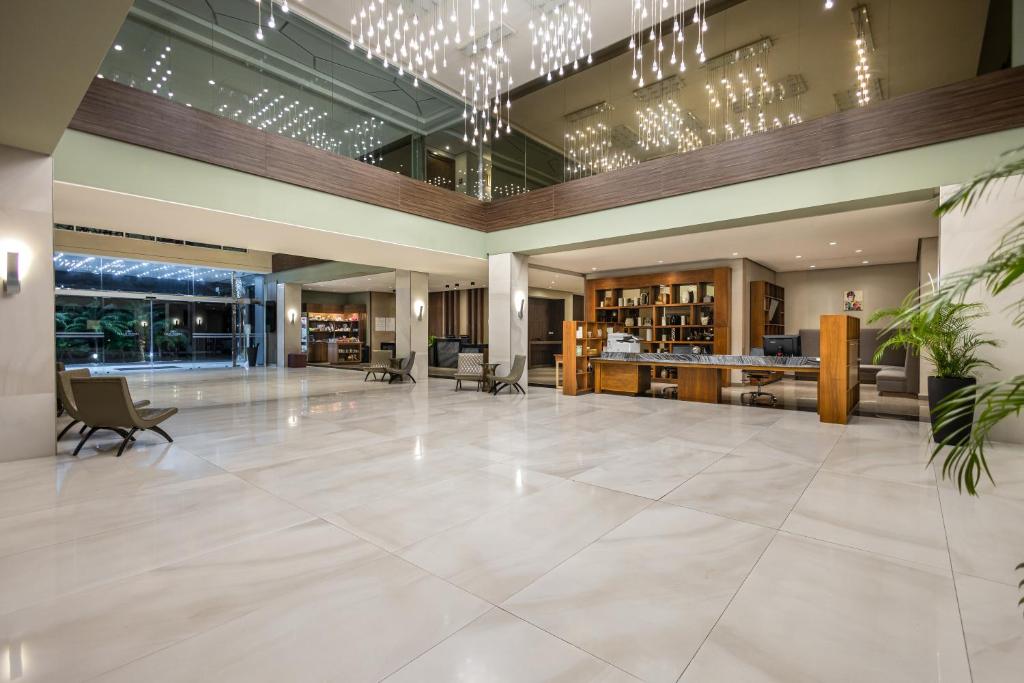 a large lobby with a reception desk and a lobby at Crowne Plaza Airport by IHG in Tocumen
