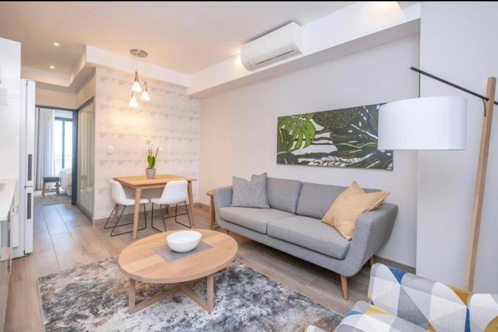 a living room with a couch and a table at The Regency Cosy Apartment- 419 in Pretoria