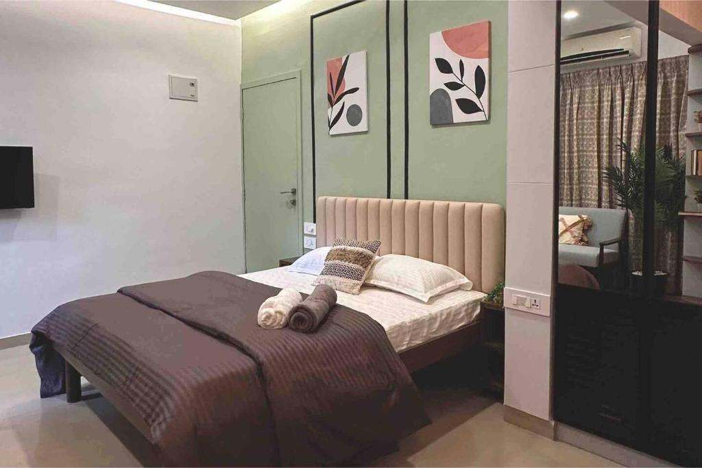 a bedroom with a bed with two towels on it at Boho Studio in Pune