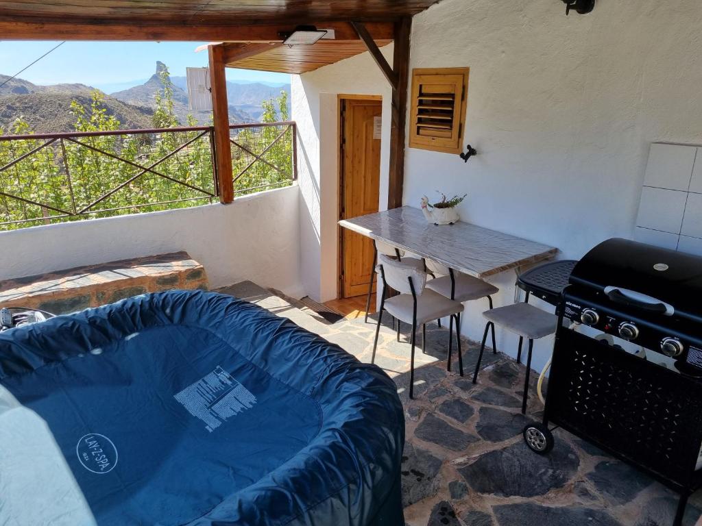 a living room with a table and a table and chairs at Casa Los Manantiales in Tejeda