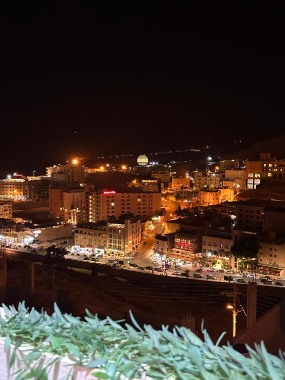 a view of a city at night with lights at Hustle's look in Wadi Musa