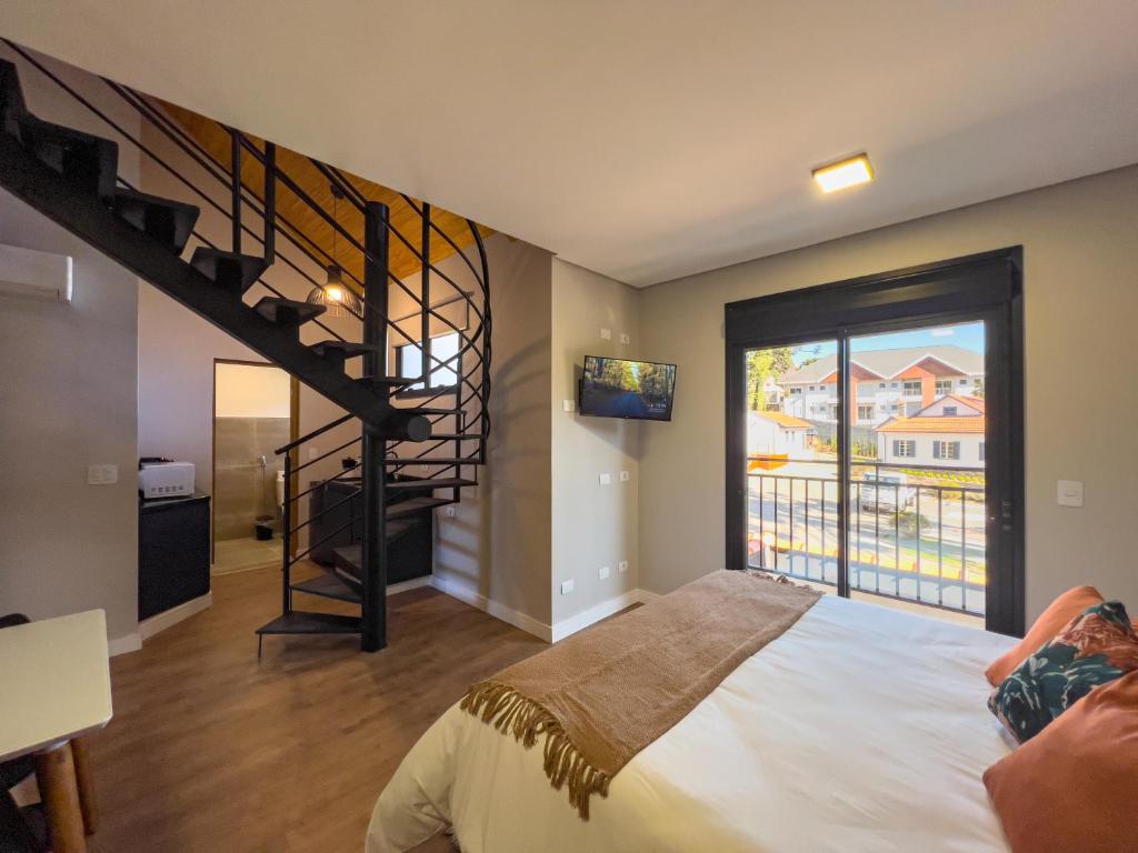 Ένα ή περισσότερα κρεβάτια σε δωμάτιο στο Parador Campos do Jordão Em Vila Capivari