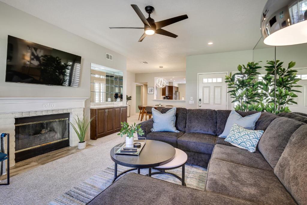 a living room with a couch and a fireplace at Beautiful Palm Desert Townhome with Community Perks! in Palm Desert