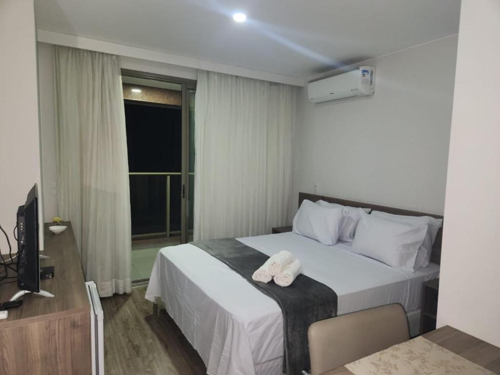 a hotel room with a bed with a towel on it at Via Premiere Suíte 409 B in Rio de Janeiro