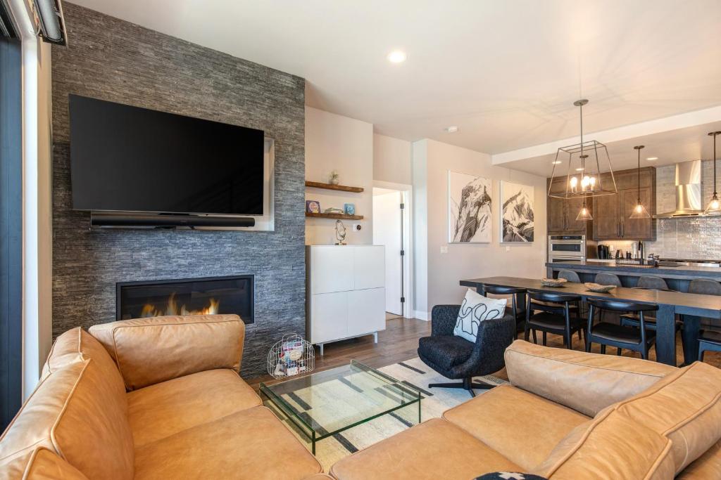 a living room with a couch and a fireplace at On Top of the Mountains - Unit B in Keetley