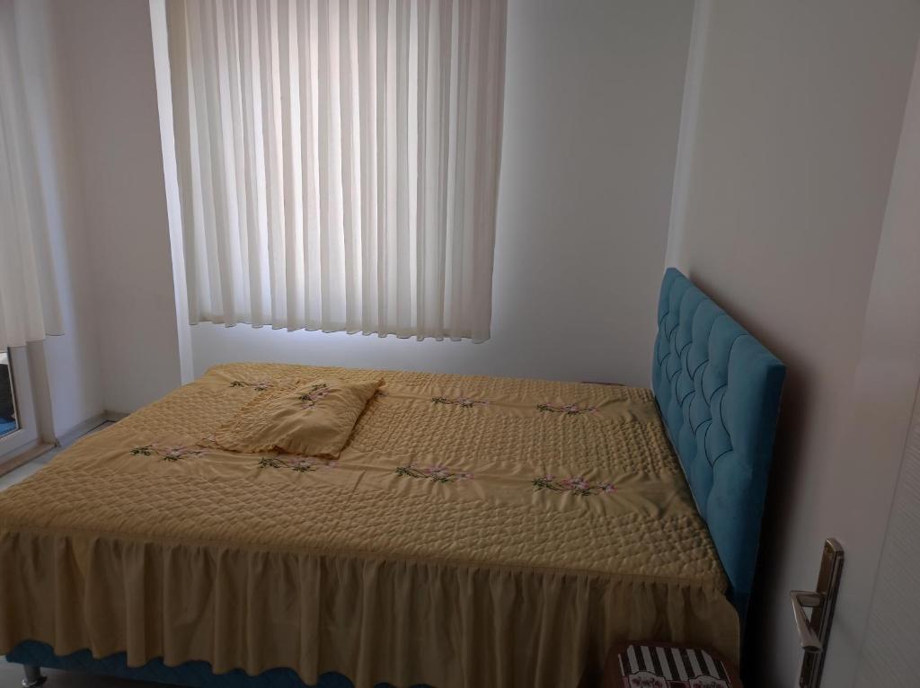 a bedroom with a bed in a room with a window at Elif home in Kas