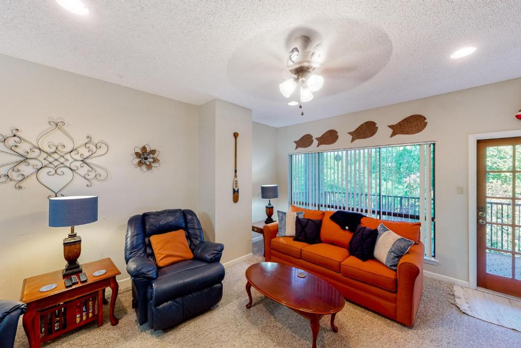 a living room with a couch and a chair at Camp Warnecke Estates Unit C204 in New Braunfels