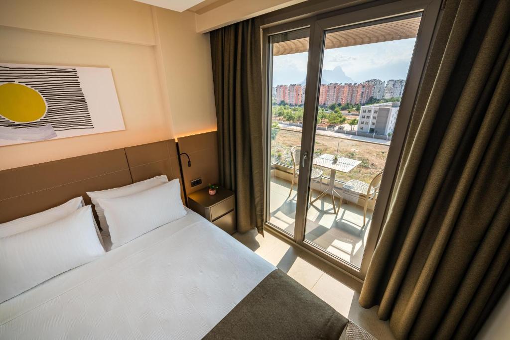 Postel nebo postele na pokoji v ubytování Casamax Suites