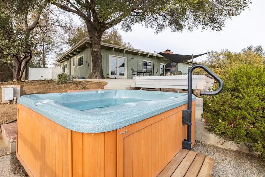 a hot tub in the backyard of a house at Black Bear Suite Hot Tub Sleeps 4 affordable in Oakhurst