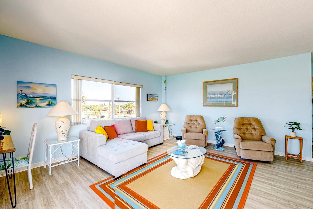 a living room with a couch and two chairs at Turtle Time Suite in Satellite Beach