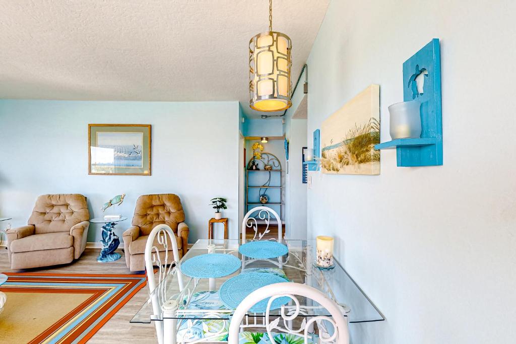 a living room with a glass table and chairs at Turtle Time Suite in Satellite Beach